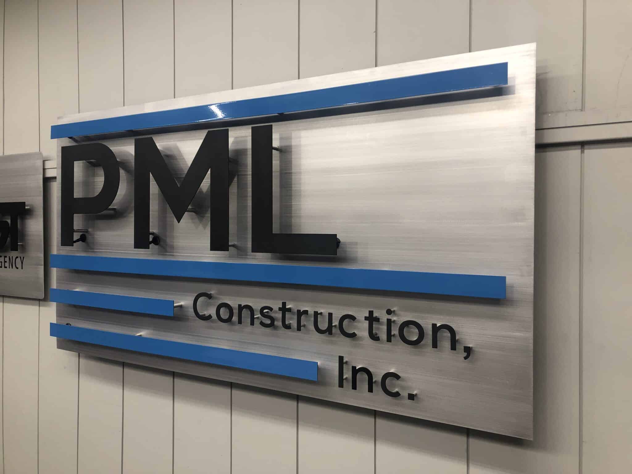 Halo-illuminated custom metal sign for PML Construction Inc. showing outdoor durability and professional fabrication quality