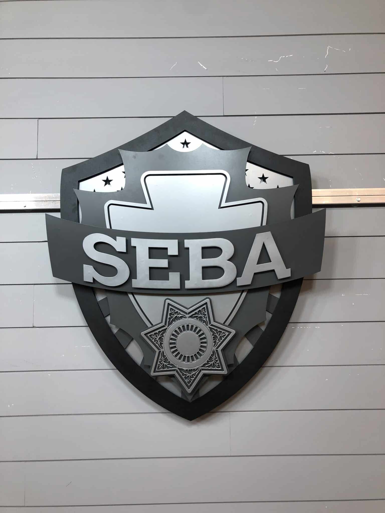 Custom halo-lit metal logo sign installed for SEBA with elegant glow effect