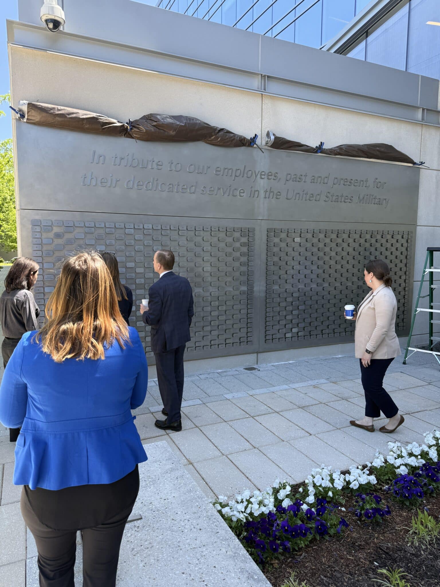 People admiring the completed Veterans Memorial Wall