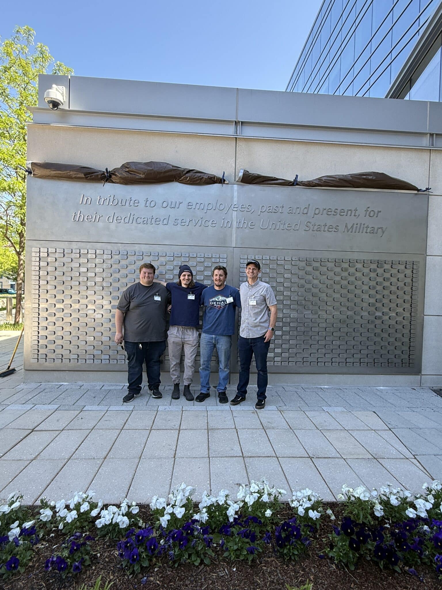 ShieldCo team photo in front of finished wall