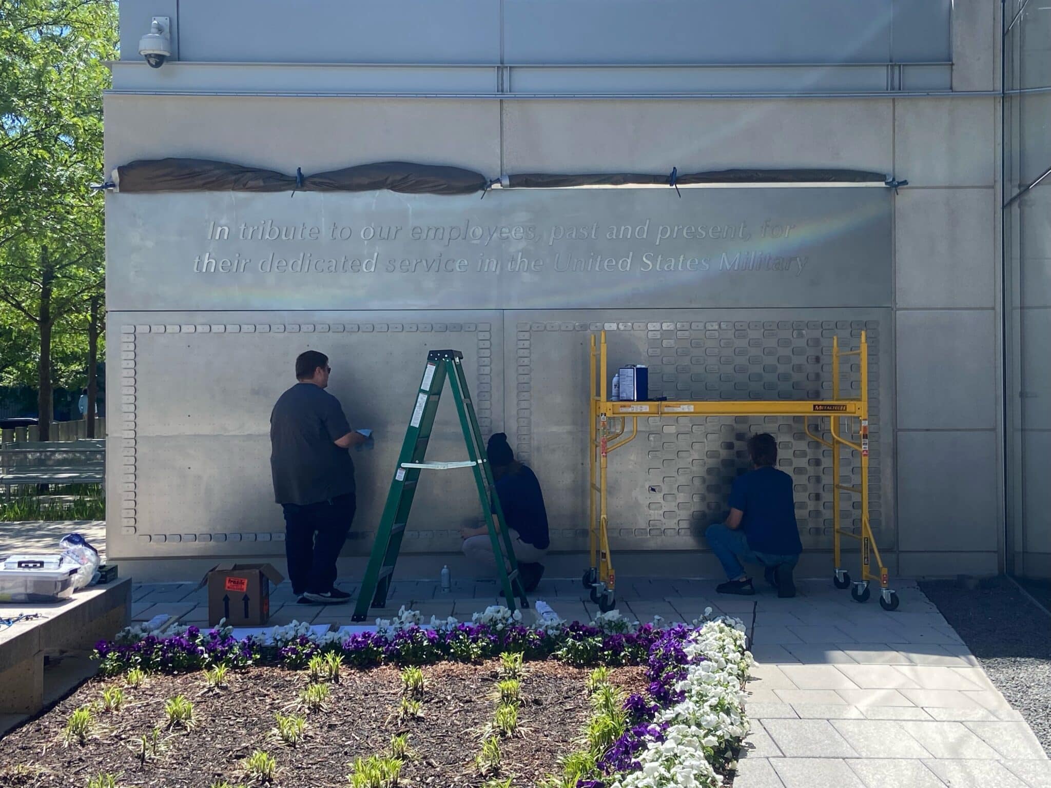 Crew installing dog tag plaques