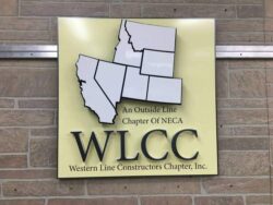 WLCC Western Line Constructors Chapter sign with the member states cut as a map above the initials.