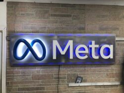 brushed steel sign for meta with neon lighting finishes