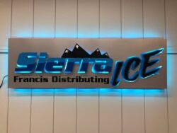 Sierra Ice Francis Distributing panel sign with mountains behind the name, halo-lit LED and glowing blue.