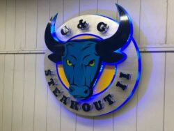 G&G Steakout II round sign with a blue bull's head and curved horns, halo-lit LED and glowing blue.