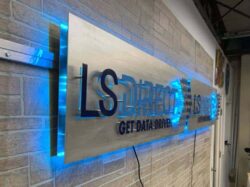 LS Direct Get Data Driven sign on a brushed panel, halo-lit LED and glowing blue along the top and bottom.