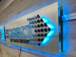The LS Direct panel from the other end, a cut arrow of dots leading into the blue LED glow.
