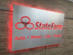 The State Farm panel from an angle, the red LED halo running the full length of the brushed face.