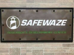 Safewaze Research & Development Center sign on a patinated steel plate with bolt heads at the corners.
