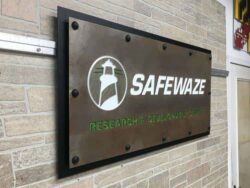 The Safewaze panel from an angle, the framed steel plate standing off the stone on its bracket.