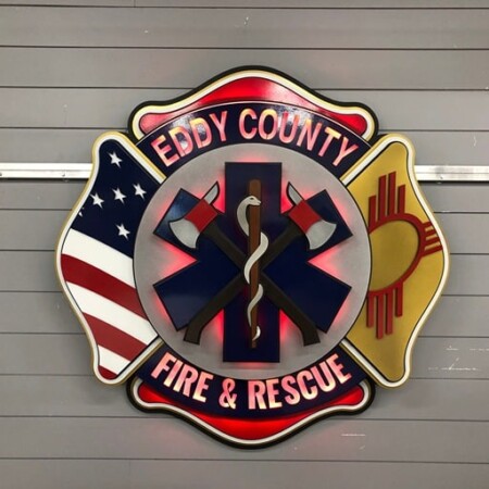 Eddy County Fire & Rescue Maltese cross badge with the US flag and the New Mexico Zia on its arms.