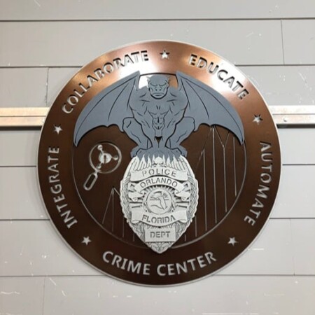 Orlando Police Department Crime Center seal in bronze and silver, a gargoyle above the department badge.