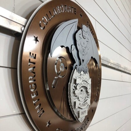 Orlando Police Crime Center seal from an angle, the bronze ring lettering curving away from the badge.