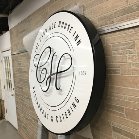 Face-lit powder-coated aluminum logo blade sign for Carriage House Inn in gloss white and black black.