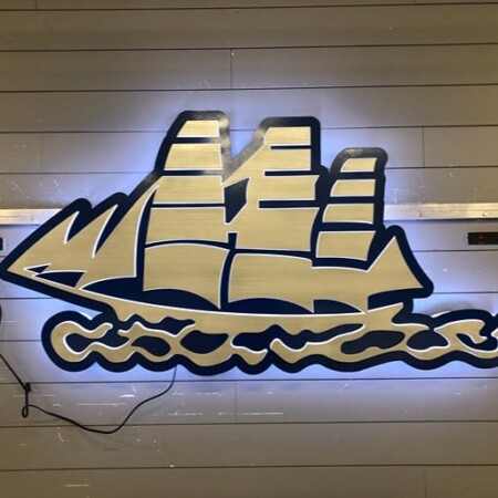 Halo-lit brushed aluminum sign for Ariel Condominium in brushed silver and navy/black.