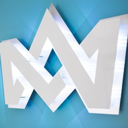 A 3d mockup of Coronation Media crown monogram against a blue wall.