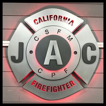 California JAC Firefighter Maltese cross badge in brushed steel, halo-lit LED and glowing red.