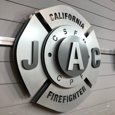 California JAC Firefighter badge angled on the wall, showing how far the layers stand apart.