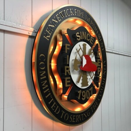 Kennewick Fire Department badge raking away down the wall, showing the depth of the stacked rings.