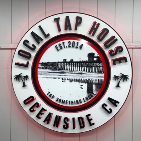 Local Tap House Oceanside round sign with a black-and-white pier photograph inside a red ring.