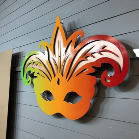 Boudreaux Cajun Steakhouse halo-lit LED Mardi Gras mask sign in a green-to-red gradient.