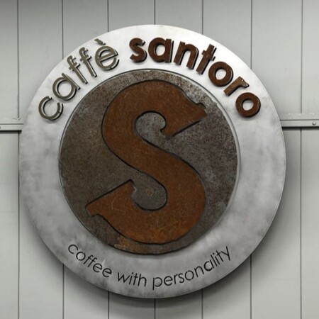 Caffè Santoro halo-lit LED round sign with a rusted steel S on a brushed disc.