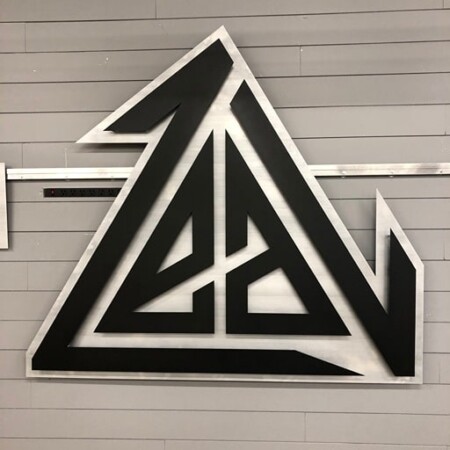 Crossfit Zeal angular mountain logo sign in black and brushed steel.