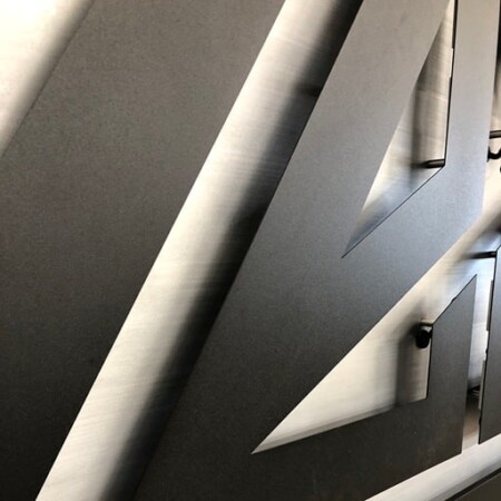 Crossfit Zeal angular mountain logo sign in black and brushed steel.