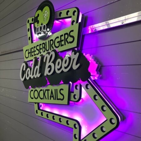 30 Hop layered metal sign lit magenta, with cheeseburgers, cold beer and cocktails panels.