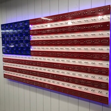 Jarrettsville Volunteer Fire Company donor flag built from engraved name plates, lit from behind.