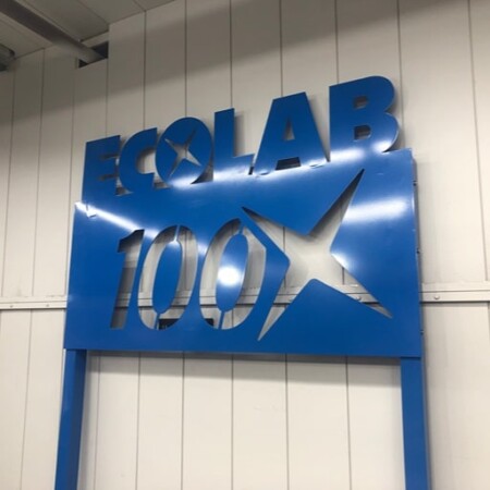 Nalco Water Ecolab 100 sign in gloss blue with the star cut clean through the panel, mounted on a frame.