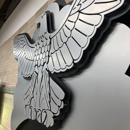 Minot Air Force Base Fire and Emergency Services eagle, layered wings spread across the wall.