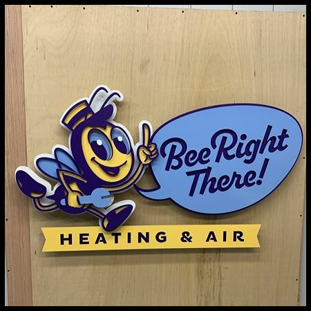 Bee Right There Heating and Air sign with a cartoon bee pointing to a speech bubble above a yellow banner.