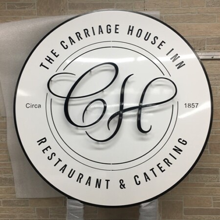 Layered powder-coated aluminum logo sign for Carriage House Inn in gloss white and black.