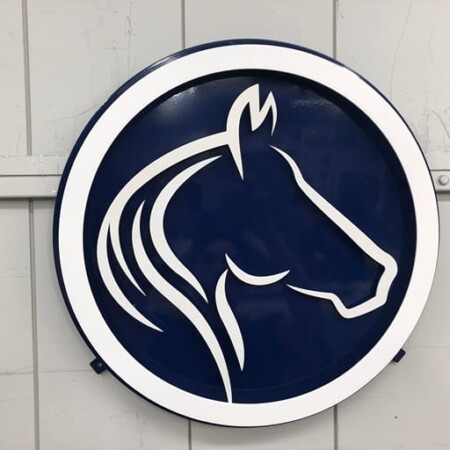 The Goddard School of Clarkston round sign, a white horse head cut against a navy disc.