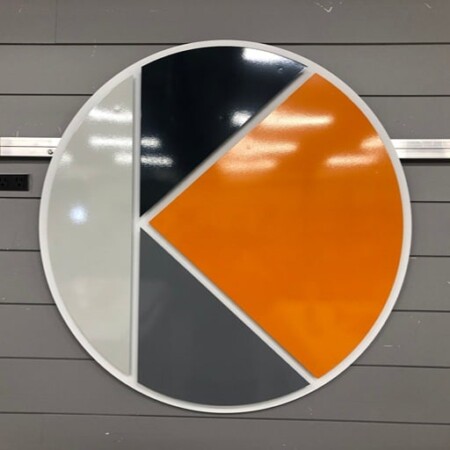 Moldgenix circular sign split into white, charcoal and orange quarters around a cut K.