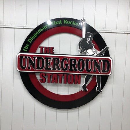 The Underground Station round sign, a guitarist silhouette beside the name on a red and black ring.