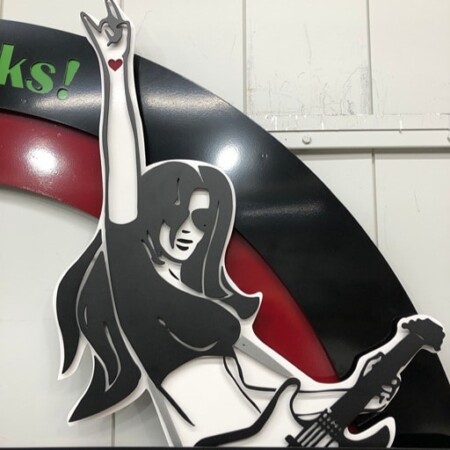 Close view of The Underground Station guitarist, the figure cut and layered over the red ring.