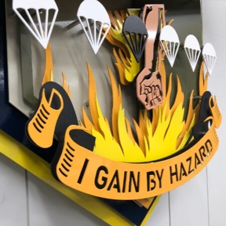 The lower half of the Jungle Skippers patch, jump boots and flames beneath the I Gain by Hazard scroll.