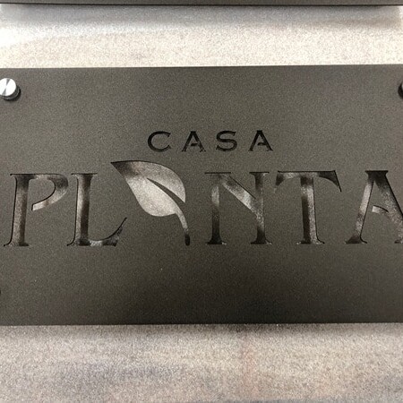 Powder-coated aluminum plaque sign for Casa Campos in matte black/charcoal silver hardware.
